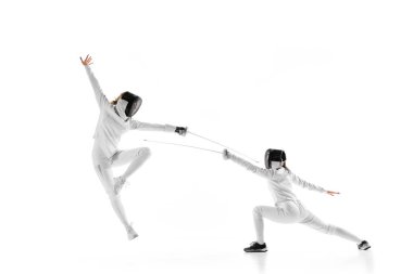 İki rakip, yüksek enerjili eskrim antrenmanında beyaz stüdyo geçmişine karşı ataklarını ve savunmalarını geliştirmeye çalışıyor. Profesyonel spor, rekabet, güç ve eylem kavramı. Ad