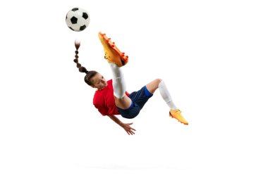 Havanın ortasında bayan futbolcu, hassas ve güçlü bisiklet tekmesi atıyor, atletizm ve beceri gösterisi yapıyor. Kadın ve spor kavramı, takım oyunları, hareket, zafer, aksiyon. Ad