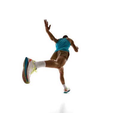 Düşük açı. Hızla hızlanan dinamik kuvvet, yoğun hareket ve ileri an beyaz stüdyo arka planına karşı hızı vurguluyor. Güç, eylem ve profesyonel atletizm kavramı.