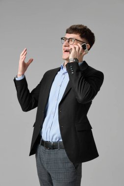 Akıllı telefondan konuşan mutlu iş adamı heyecan ve neşe içinde elini kaldırdı. Başarılı anlaşma kavramı, duygular, iletişim, satış başarısı, mobil yaşam tarzı, modern iş.