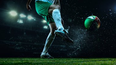 Rugby player kicking colorful ball under 3D stadium lights with water splash. Concept of teamwork and focus for sports communication, editorial features, and motivational design.