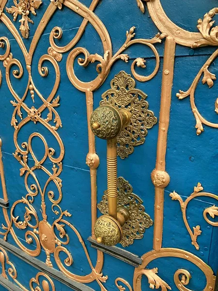 large door, historic entrance gate, blue gate with golden decorations, old tenement house, decorations and ornaments, golden handle