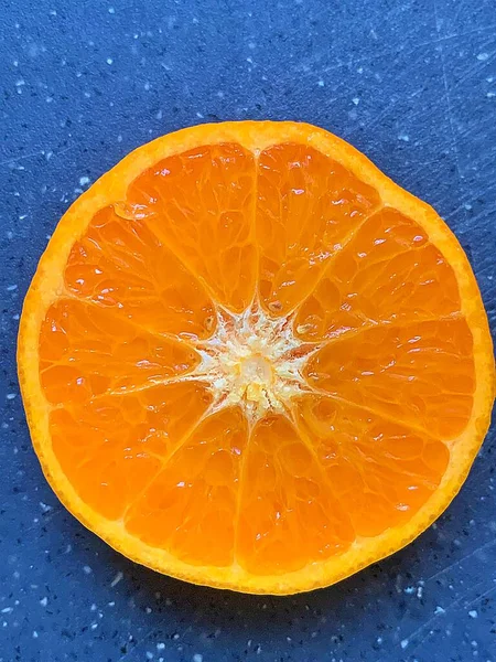 orange cut in half, juicy fruit, citrus, fruit with a high juice content, fresh vitamins, orange on a blue background