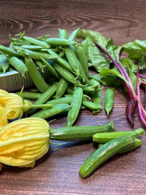 Genç kabaklar, sarı çiçekli küçük kabaklar, kabak çiçekleri, yeşil bezelyeler, küçük bezelyeler, taze pancar kökleri, pazı, bahçe hasadı, doğal sebzeler.