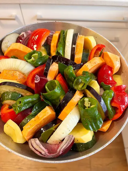pan full of chopped vegetables, colorful vegetables, preparing a vegetable dish, sweet potato, peppers, onion, eggplant
