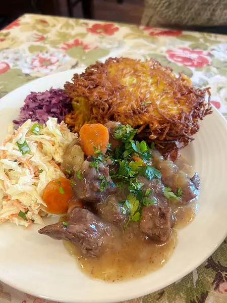 large pork chop, breading on the cutlet, mashed potatoes, lunch dish, typical Polish dinner, potato pancakes with goulash, salads, dinner in a restaurant