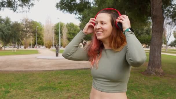 Usmívající Žena Červených Sluchátkách Chytrým Telefonem Připravená Běžet — Stock video
