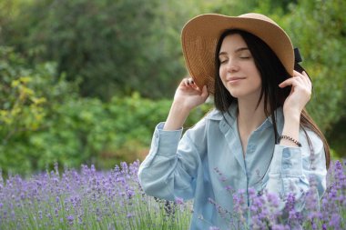 Beautiful young girl on lavender field. Sunset. Attractive young female outdoors.