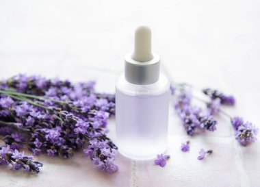 Spa products and lavender flowers.  Aromatherapy lavender bath salt and massage oil