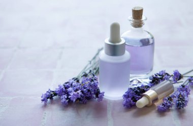 Spa products and lavender flowers.  Aromatherapy lavender bath salt and massage oil