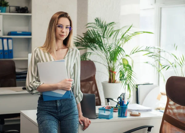 stock image Young woman working on a computer in her office