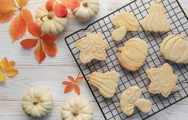 Stock image Autumn baking. Cookies in the form of pumpkin and leaves on the table. Cozy autumn concept.