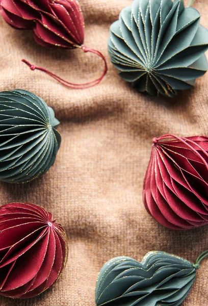 Stock image Handmade eco paper ball, closeup view. Christmas holiday decorations on a brown knitted background. 