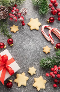 Noel arkaplanı zencefilli kurabiyeler, hediye kutuları ve koyu beton arka planda köknar dalları. Kış festivali konsepti. Düz yat, boşluğu kopyala.
