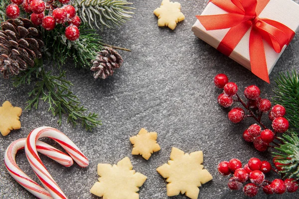 Stock image Christmas background with gingerbread cookies, gift boxe and fir branches  on darck concrete background. Winter festive concept. Flat lay, copy space.