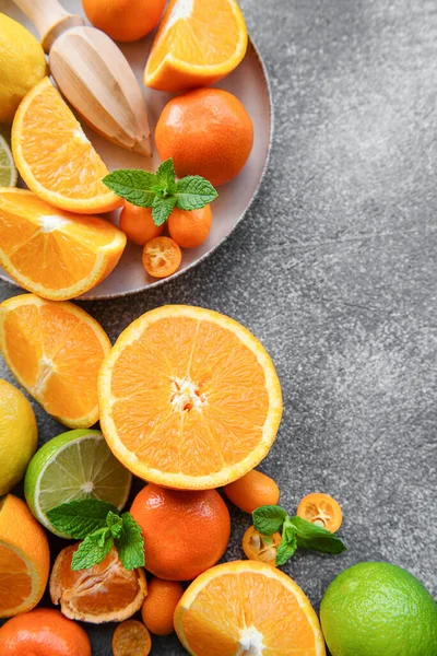 Sliced fresh citrus  on a dark concrete background. Healthy food. 