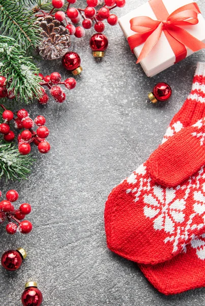 stock image Christmas background with fir tree, red mittens and decor on concrete background. Top view with copy space