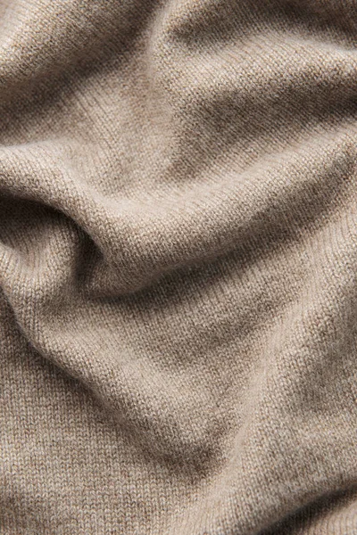 Fine grey cashmere texture close-up. Warm cashmere fabric as background, top view