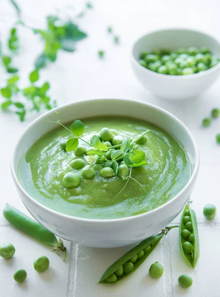 stock image Fresh green pea soup bowl on gray concrete background