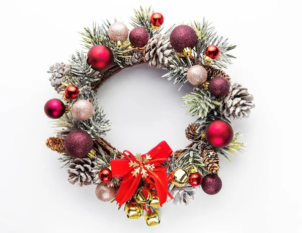 Decorative festive Christmas wreath. Wreath with red and golden christmas toys on white background