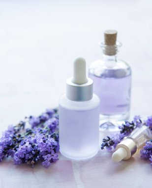 Spa products and lavender flowers.  Aromatherapy lavender bath salt and massage oil