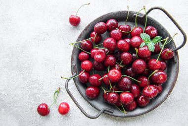 Fresh red cherries fruit  on a concrete background