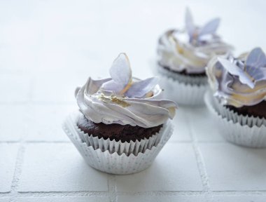 Birthday holiday sweet cupcakes with butterfly decorations