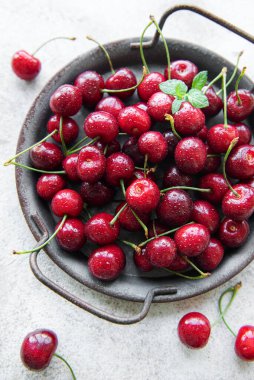 Fresh red cherries fruit  on a concrete background
