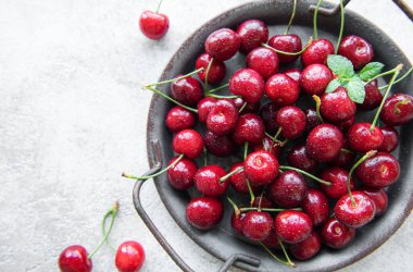 Fresh red cherries fruit  on a concrete background