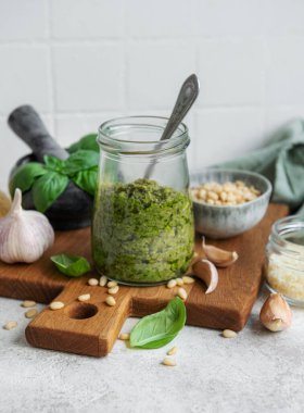 Taze pesto sosu. Yeşil fesleğen pesto. Pesto sosu için malzemeler - Taze fesleğen, çam fıstığı, zeytinyağı ve peynir