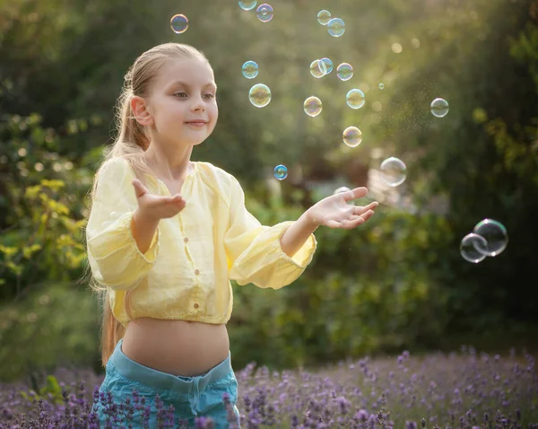 Beautiful Little Girl Catches Soap Bubbles Field Lavender — kuvapankkivalokuva