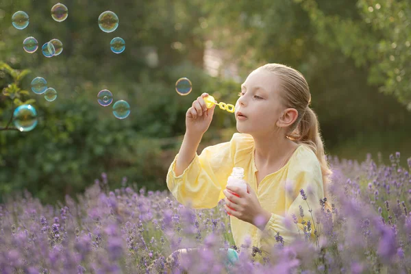 Beautiful Little Girl Catches Soap Bubbles Field Lavender — kuvapankkivalokuva
