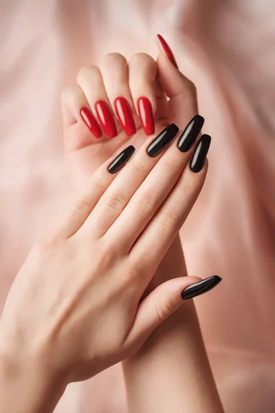 Hands Young Girl Red Black Manicure Nails Beige Silk Background – stockfoto
