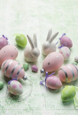 Decorative rabbits and  Easter eggs on the table. The concept of Easter holidays.