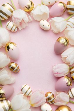 Easter golden eggs and pink tulips on pink  background. Top view. Happy Easter composition. Greeting card.