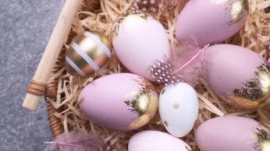 Colorful Easter eggs  rotation. Happy Easter background. Top view Rotating Of Colorful Easter Eggs on a wicker plate. 