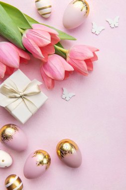 Happy easter holiday greeting card. Bouquet of pink tulips and Easter egg on pink background. Space for text