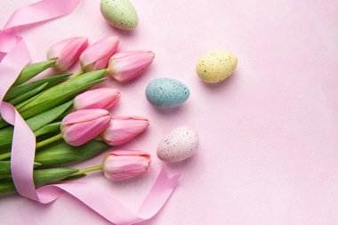 Happy easter holiday greeting card. Bouquet of pink tulips and Easter egg on pink background. Space for text