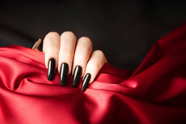 Hands Young Girl Black Manicure Nails Holding Red Satin Cloth — Stok Foto