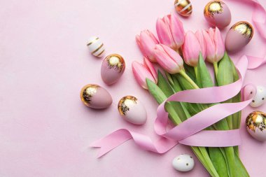 Happy easter holiday greeting card. Bouquet of pink tulips and Easter egg on pink background. Space for text