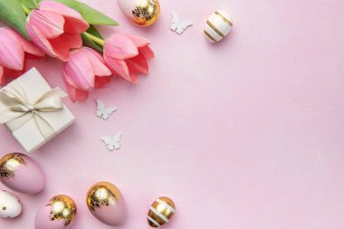 Happy easter holiday greeting card. Bouquet of pink tulips and Easter egg on pink background. Space for text