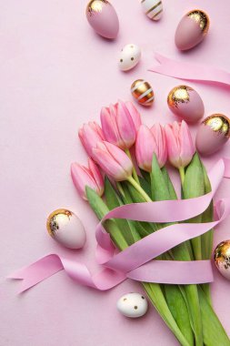 Happy easter holiday greeting card. Bouquet of pink tulips and Easter egg on pink background. Space for text