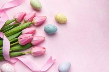 Happy easter holiday greeting card. Bouquet of pink tulips and Easter egg on pink background. Space for text