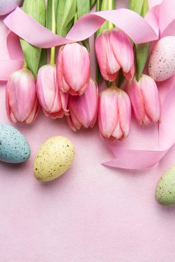 Happy easter holiday greeting card. Bouquet of pink tulips and Easter egg on pink background. Space for text