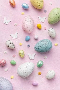 Happy Easter concept. Flat lay Easter eggs on  pink concrete background. Top view 