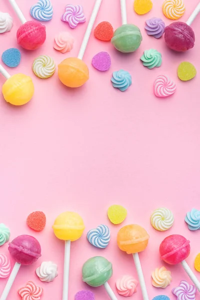 stock image Colorful sweet lollipops and candies over pink background.  Flat lay, top view