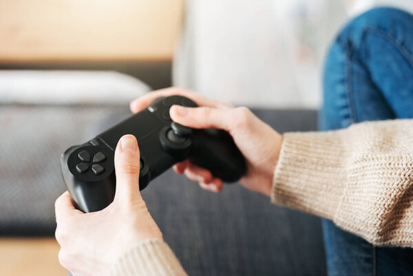 A  girl holding game controller playing video games