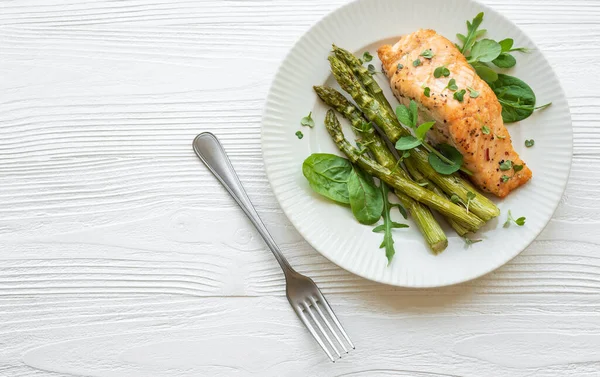 Stock image Baked Delicious salmon, green asparagus with vegetables on plate 