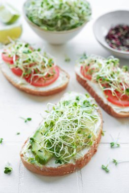 Sağlıklı beslenme. Domatesli sandviç, avokado ve taze mikroçerez..