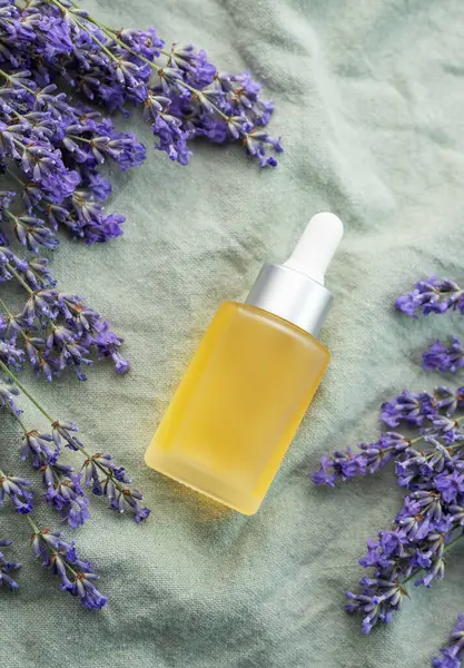 Lavender spa. Lavender  natural essential oil and fresh lavender on a textile background.
